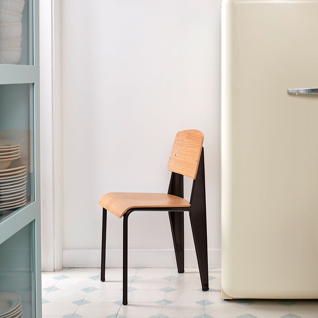 Sedia standard con tubo d'acciaio estetico ingegneristico e legno massello con design strutturale di Jean Prouvé per sala da pranzo